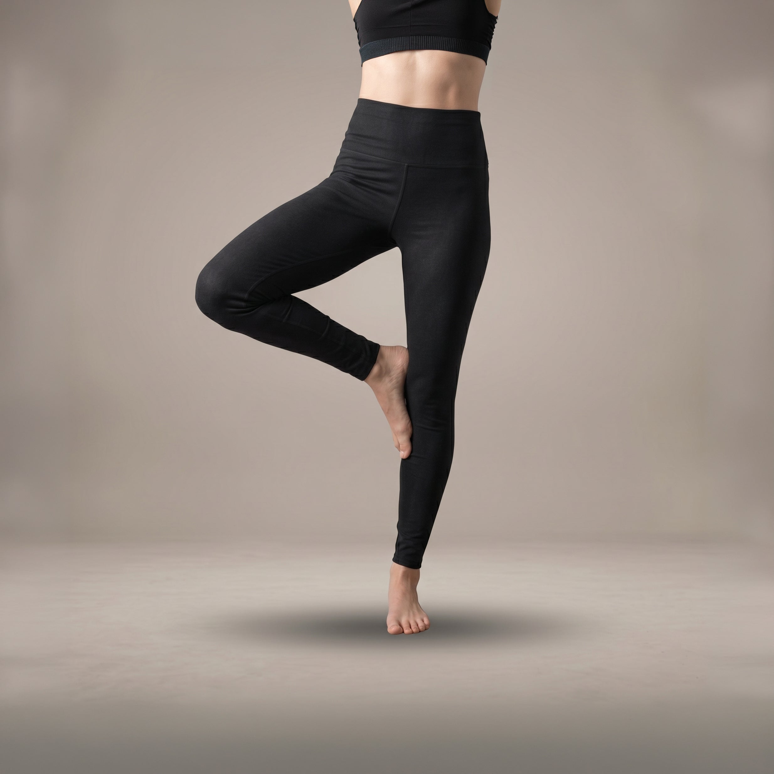 High-waisted black hemp cotton movement leggings by B108 Design on model in studio pose.