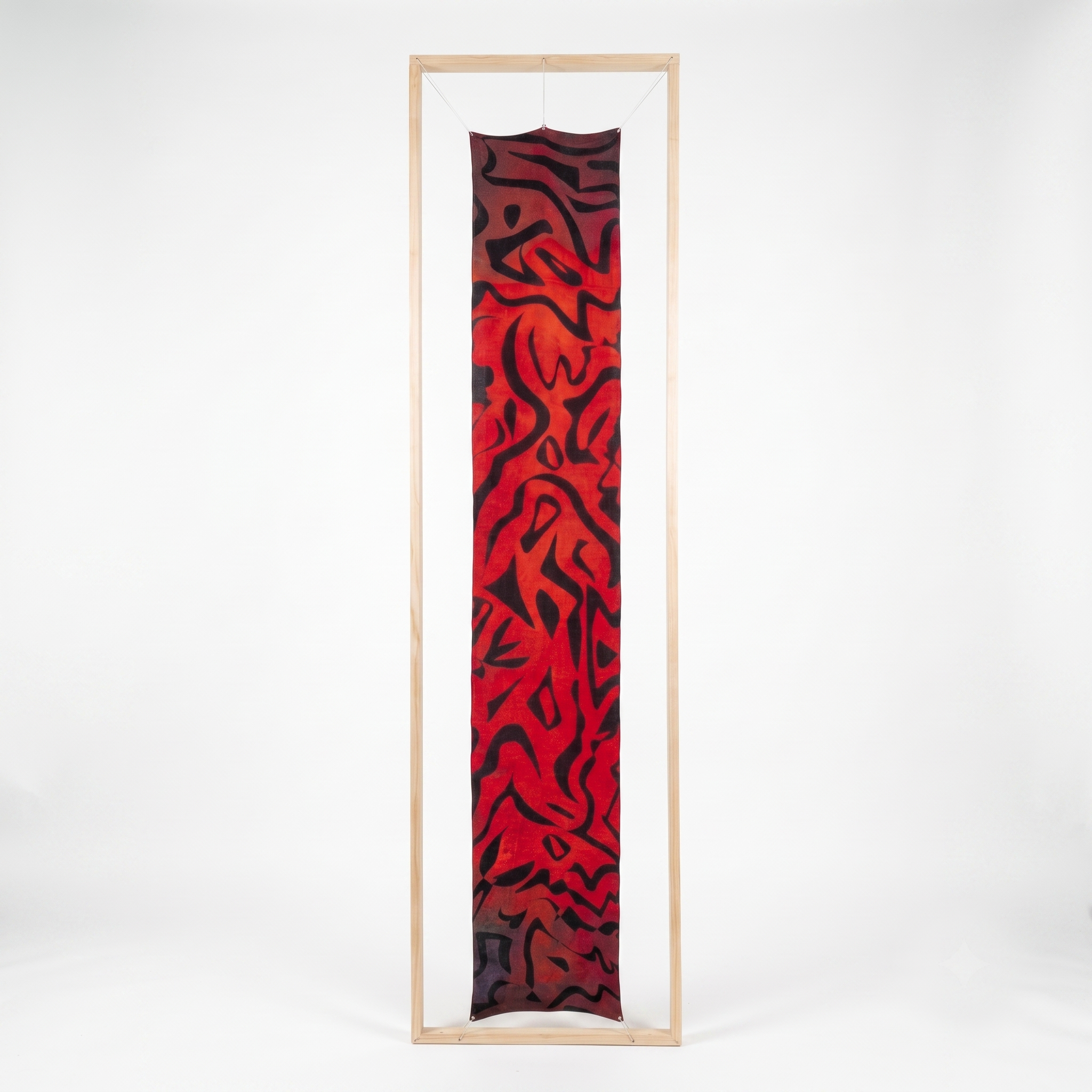 Tectonic Ember Wool-Silk Scarf stretched on a vertical timber frame against a white background, showing the full 30x180cm artwork with black graphic lines over a crimson gradient background.

