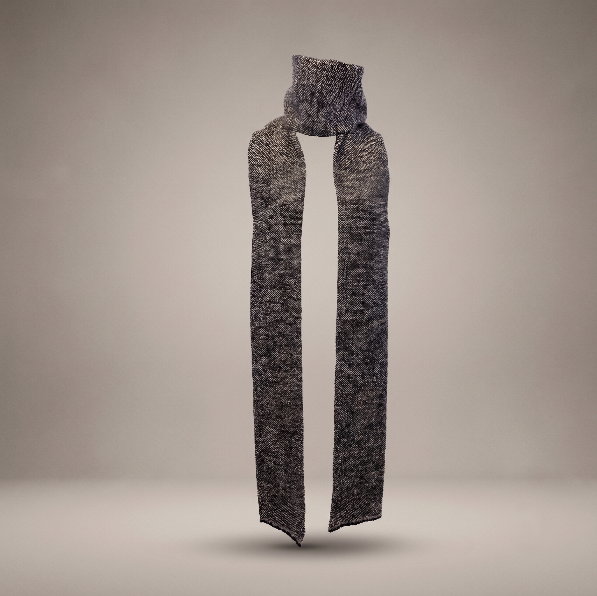 Long narrow knit wool scarf in a heathered charcoal grey and black pattern by B108 Design, floating against a neutral studio background.
