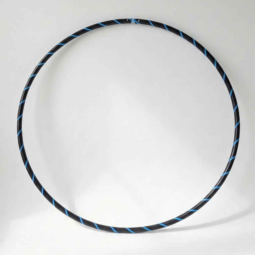 Studio shot of the B108 DESIGN Archival Dance Hoop in Blueberry Bliss featuring a blue and black spiral grip tape pattern against a white backdrop.