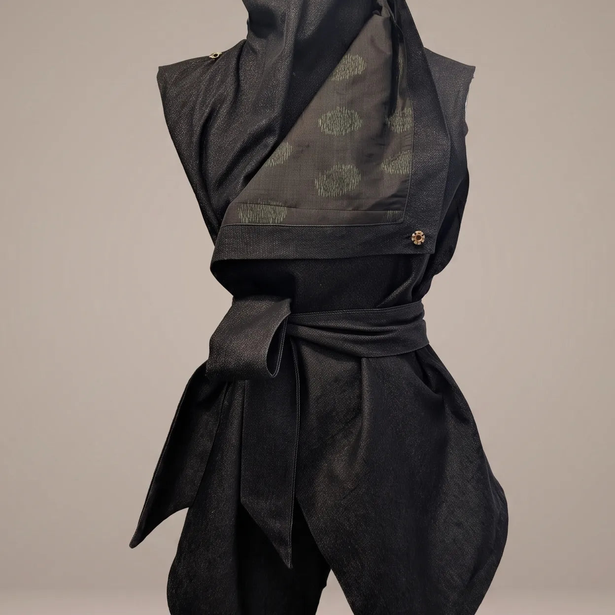 Close-up detail of the Black Denim Kimono Vest, highlighting the dark vintage Japanese silk lining with olive green dotted motifs, metallic hardware detail, and wrapped sash waist by B108 DESIGN.