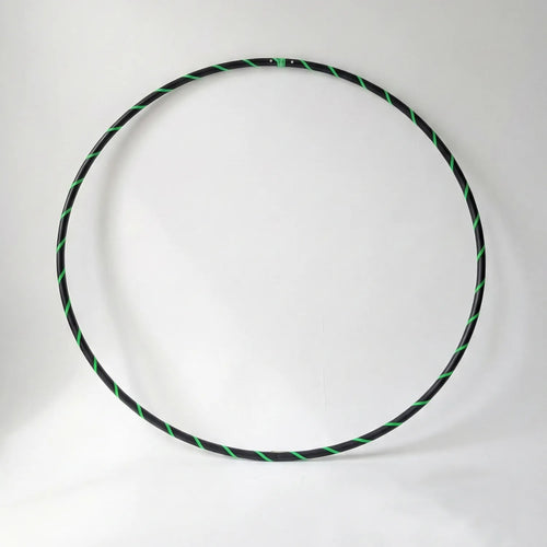 Studio shot of the B108 DESIGN Archival Dance Hoop in Lime Love featuring a fluoro green and black spiral grip tape pattern against a white backdrop.