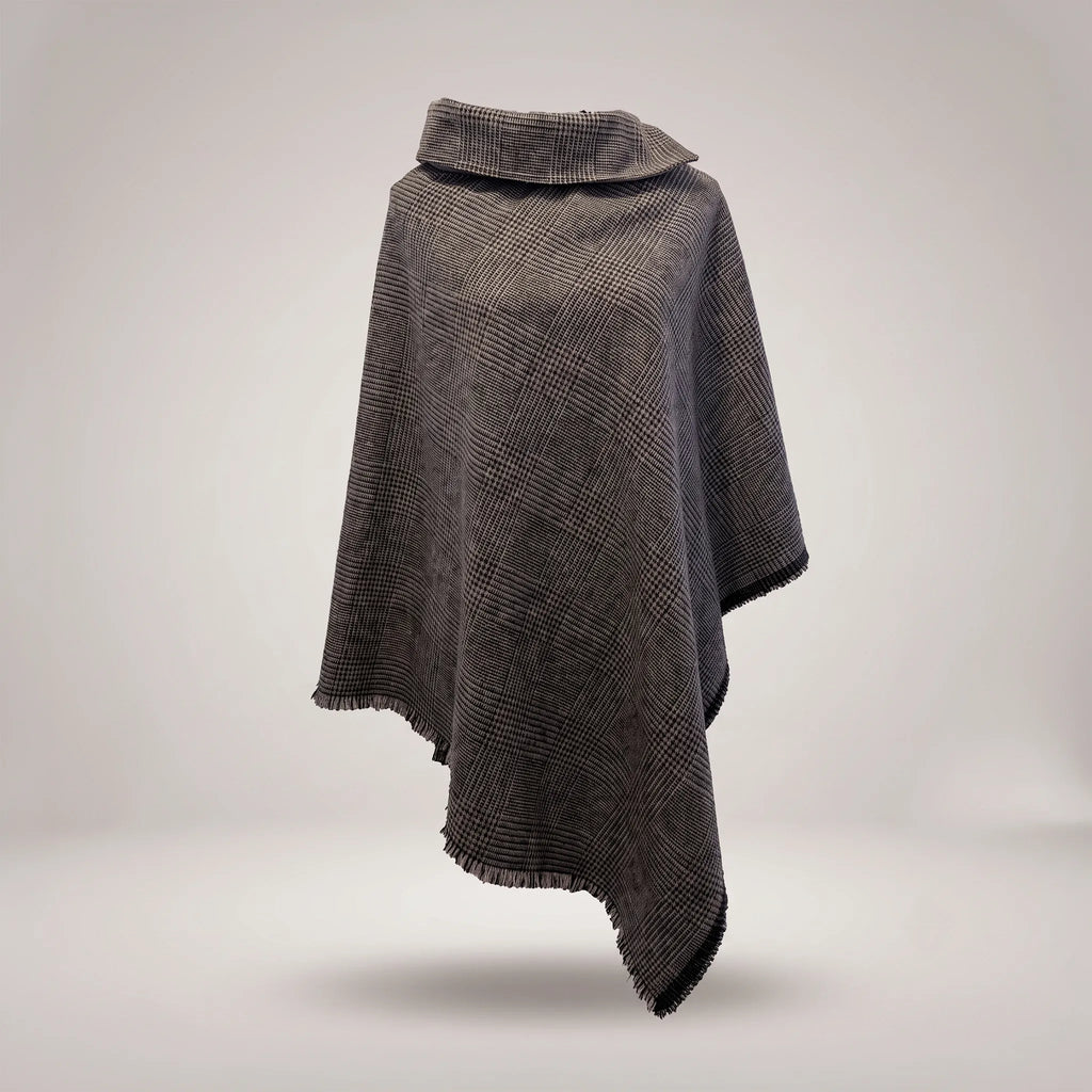 Front view of the luxury Bulgarian wool cape by B108 Design in a charcoal and grey Glen plaid pattern with a cowl neck collar and fringed asymmetrical hem.