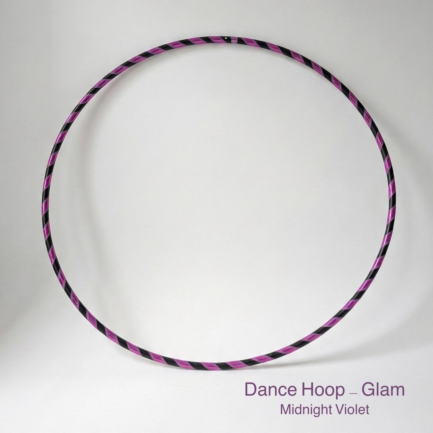 Dance hula hoop ON SALE – Midnight Violet Glam Edition. Professional black tubing featuring a reflective purple mirror and grip tape spiral design for dance and fitness.