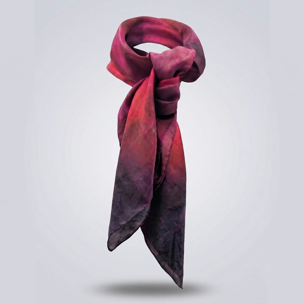 Front view of the Ember luxury silk Habotai scarf by B108 Design tied in a classic loop, featuring a hand-dyed gradient blend of magenta, deep crimson, and dark plum tones.