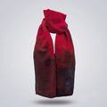 Front view of the Ember luxury silk-wool scarf by B108 Design draped in a loose knot, featuring a rich crimson red gradient shading into deep charcoal and dark burgundy tones.