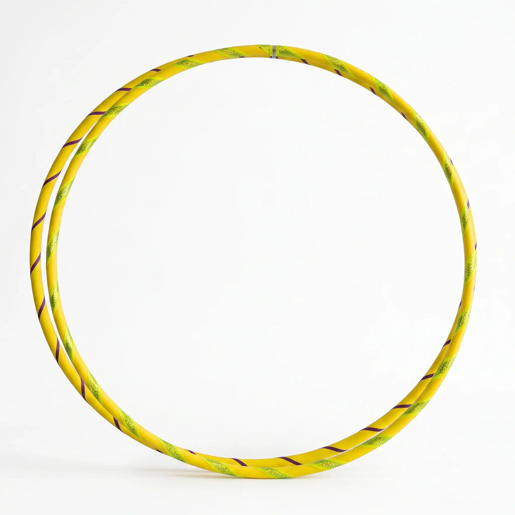 Studio shot of a twin set of B108 DESIGN kids dance hula hoops in Lemon Drop yellow with metallic tape accents against a clean white background.
