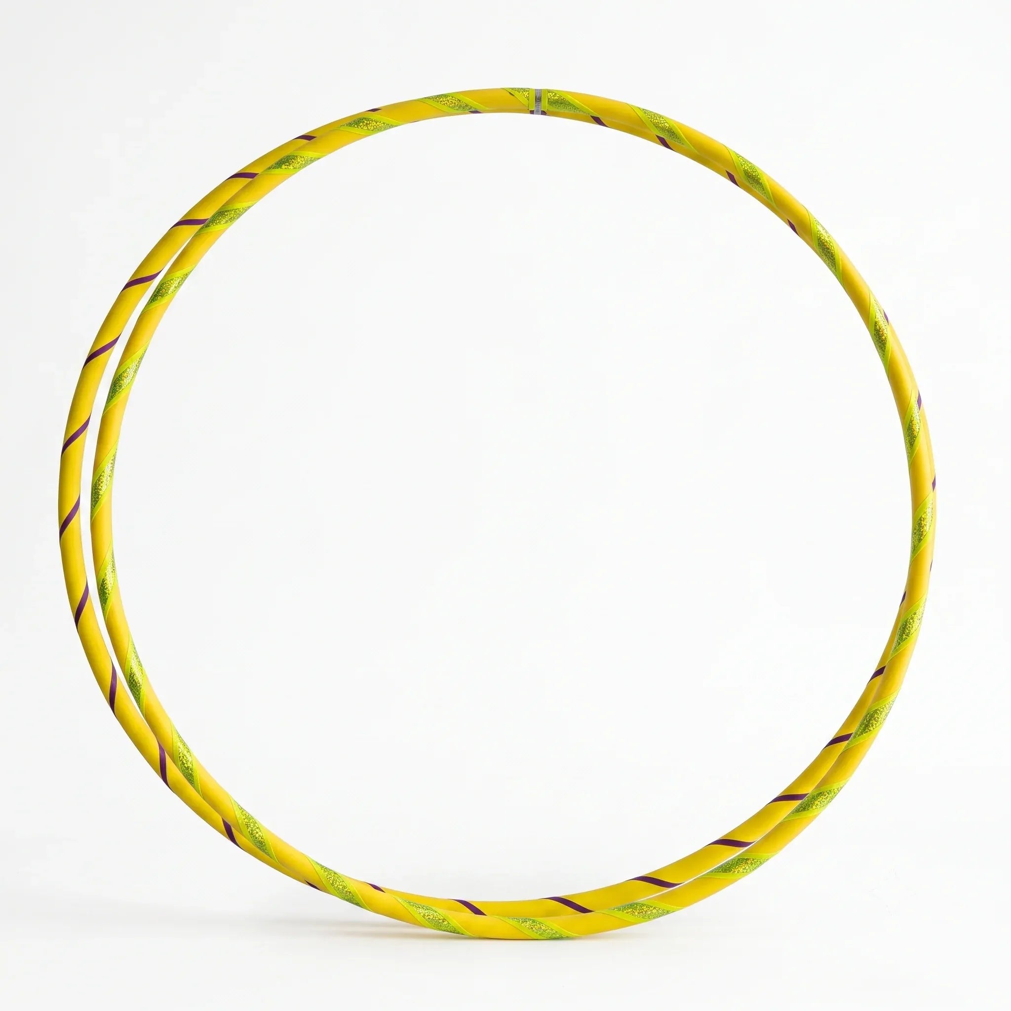 Studio shot of a twin set of B108 DESIGN kids dance hula hoops in Lemon Drop yellow with metallic tape accents against a clean white background.