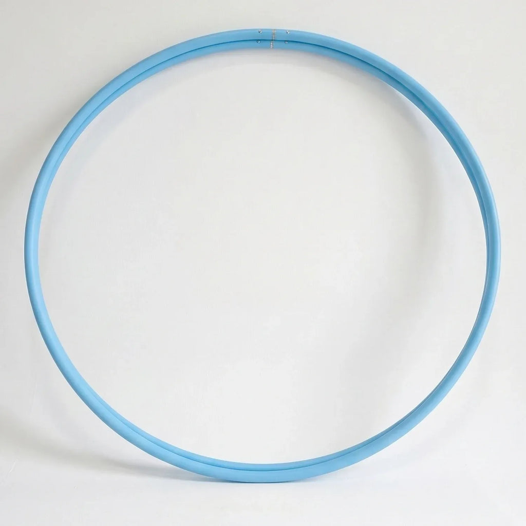 Studio shot of a twin set of B108 DESIGN kids dance hula hoops in solid sky blue stacked together against a clean white background. 