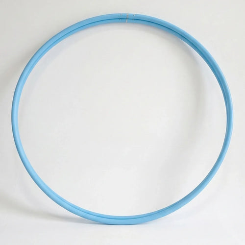 Studio shot of a twin set of B108 DESIGN kids dance hula hoops in solid sky blue stacked together against a clean white background. 