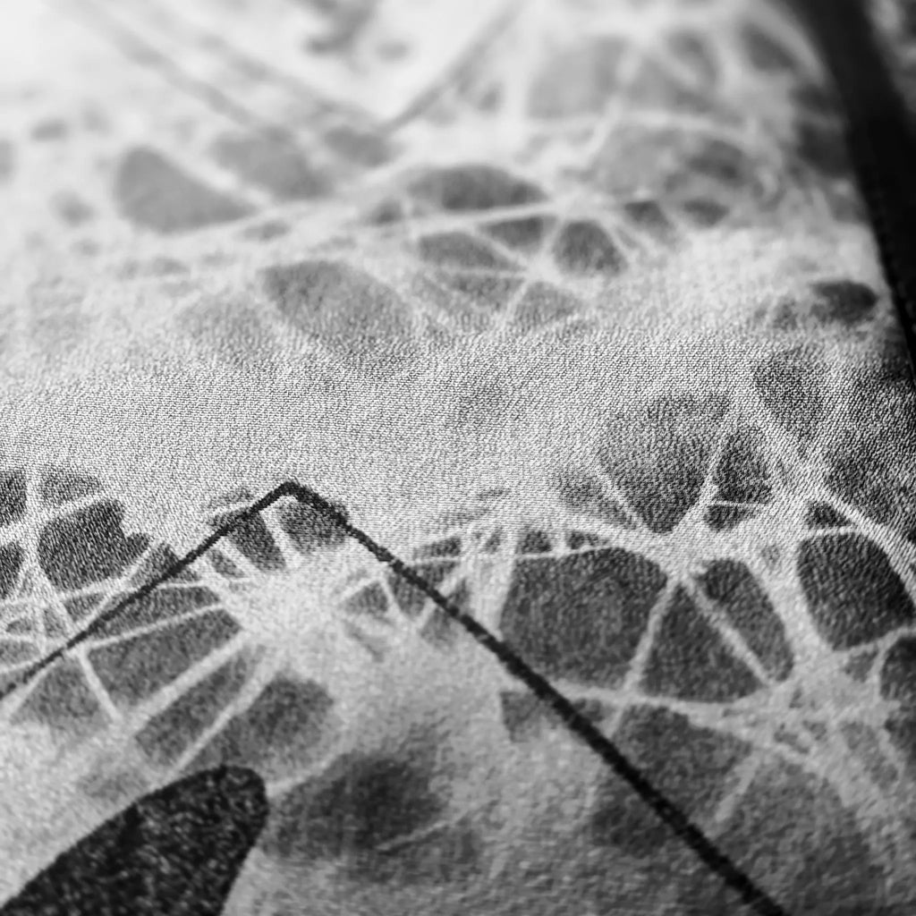 Close-up macro detail of the custom-printed silk lining fabric by B108 Design, showcasing a high-texture abstract web pattern in monochrome tones.