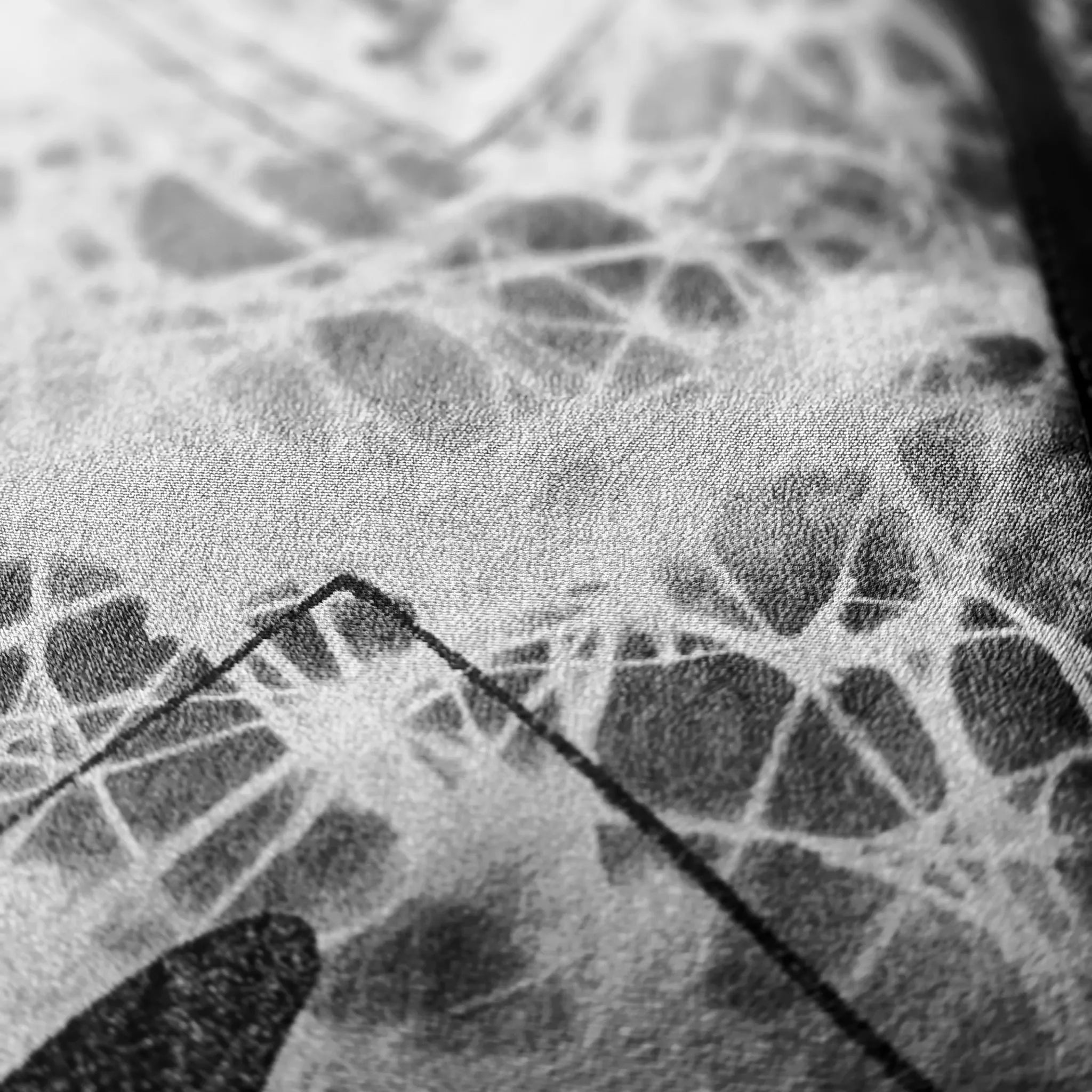 Close-up macro detail of the custom-printed silk lining fabric by B108 Design, showcasing a high-texture abstract web pattern in monochrome tones.