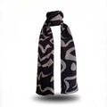 B108 Tectonica Wool-Silk Scarf in Monochrome featuring a bold abstract grey and black graphic pattern wrapped against a white background.